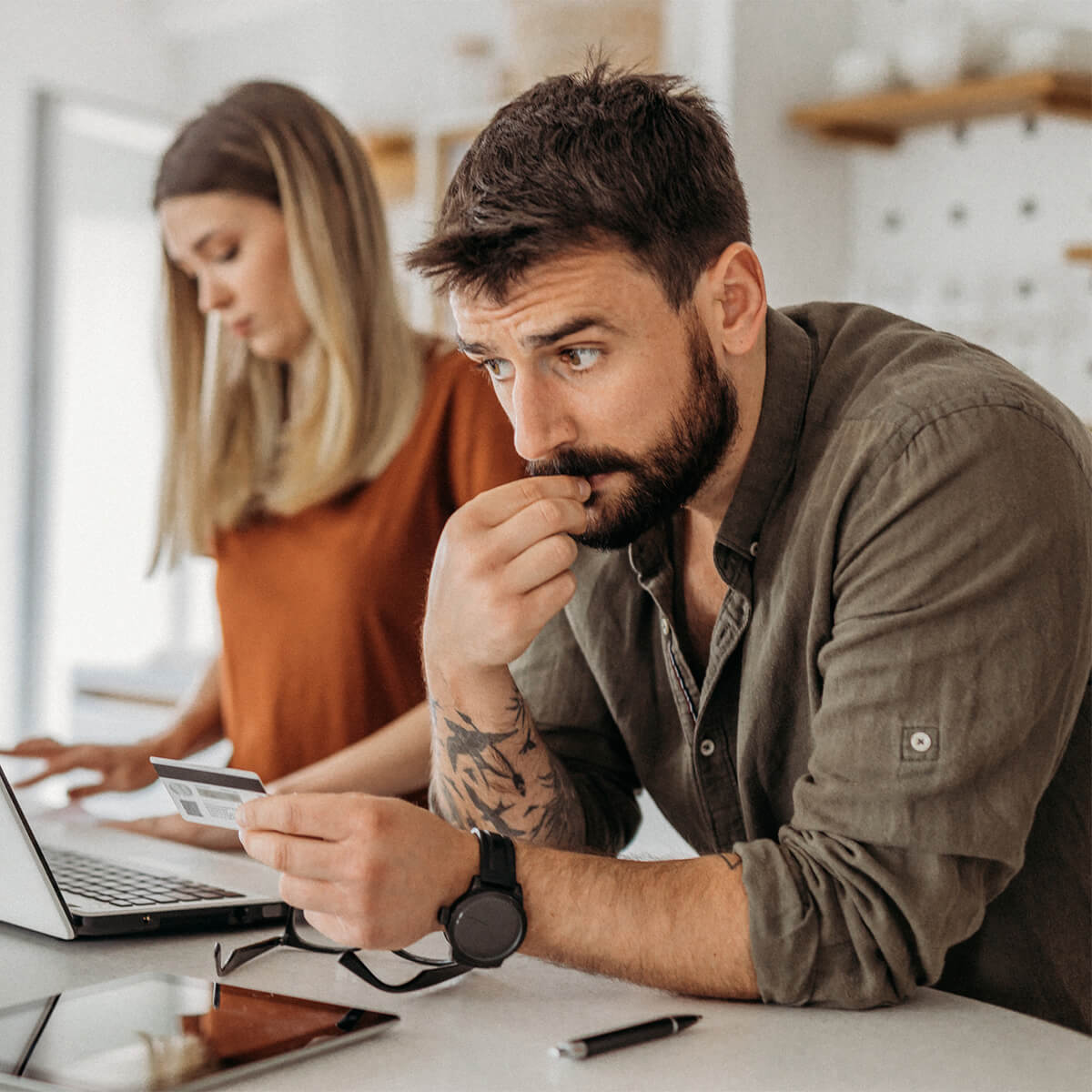 Couple in the kitchen using credit card