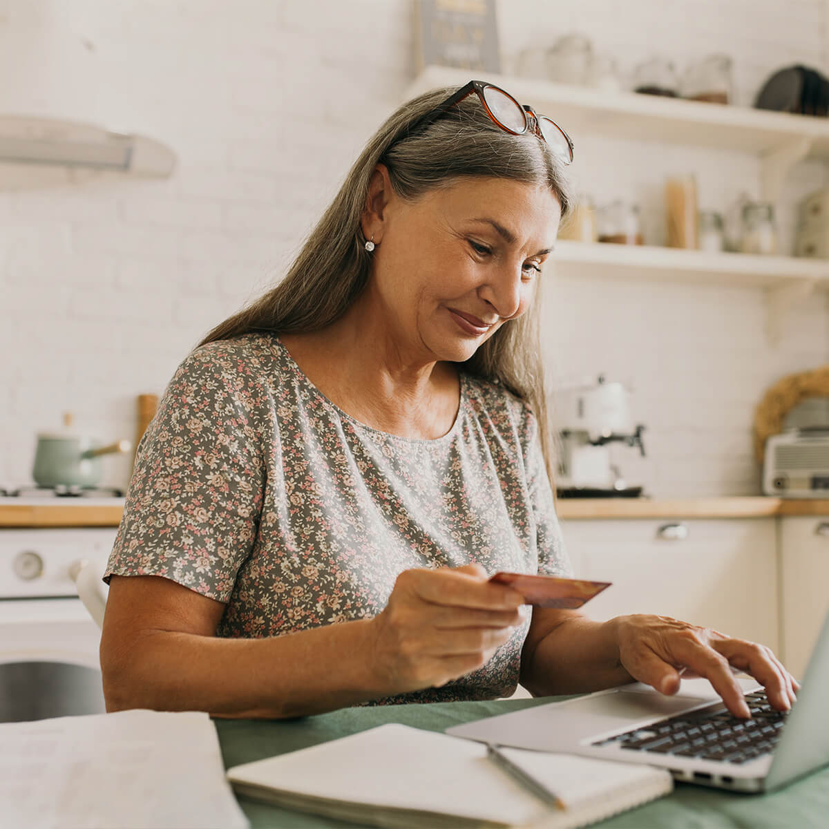 Happy senior woman making online payments-stock photo