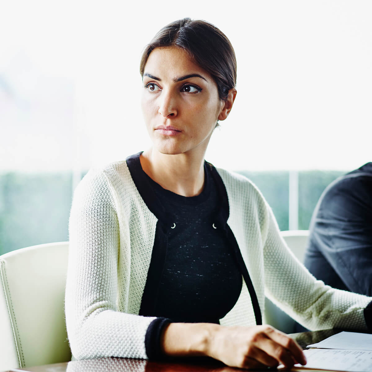 A woman wondering how long a bankruptcy will last holds papers