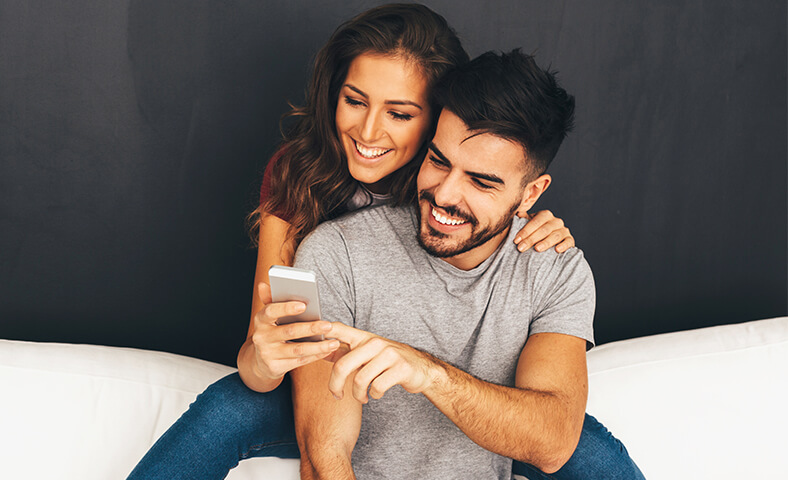 Couple going over finances on smartphone