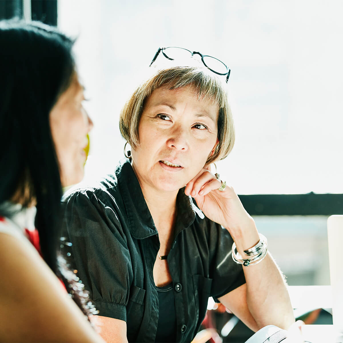 Two women talking about money