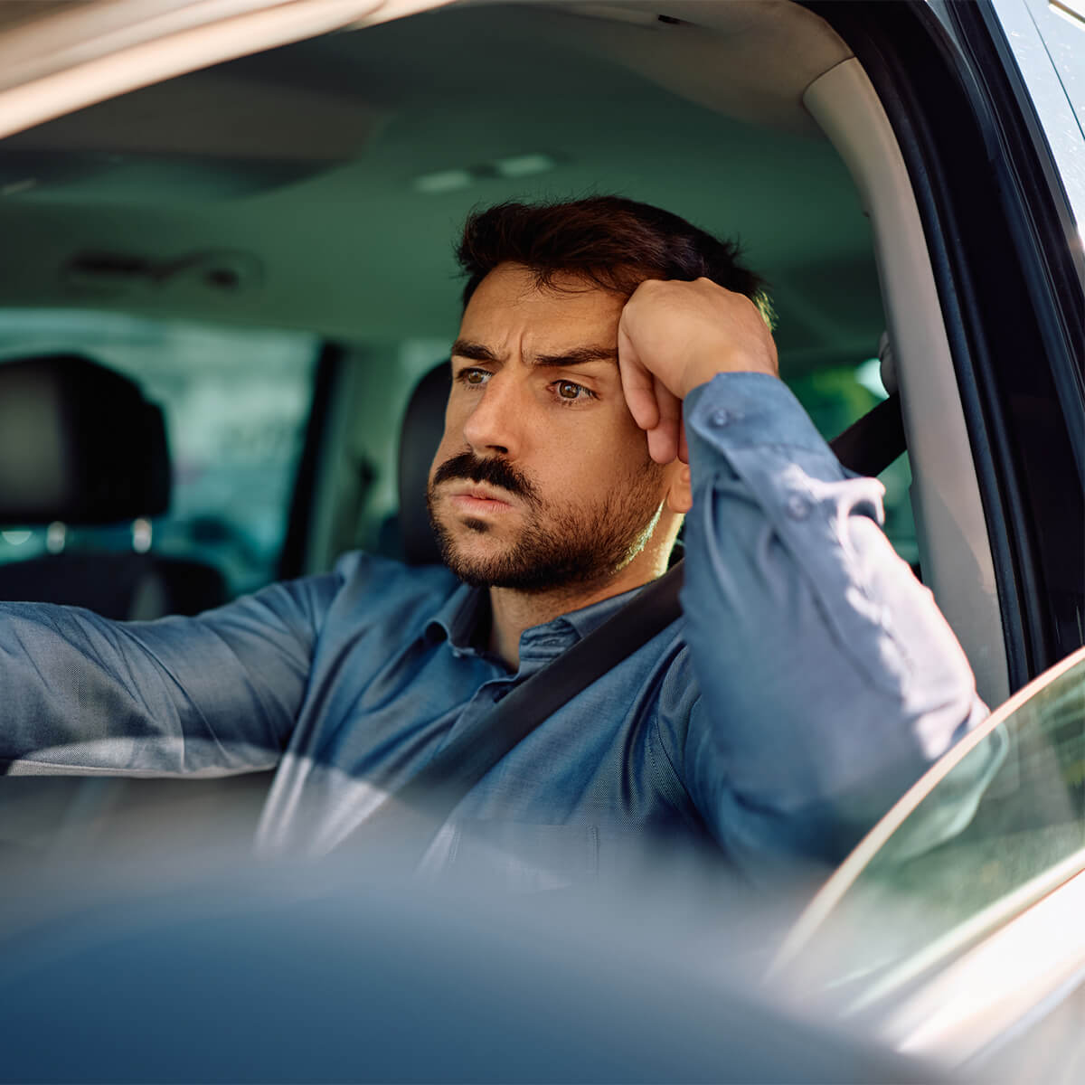 Displeased driver stuck in a traffic jam. - stock photo