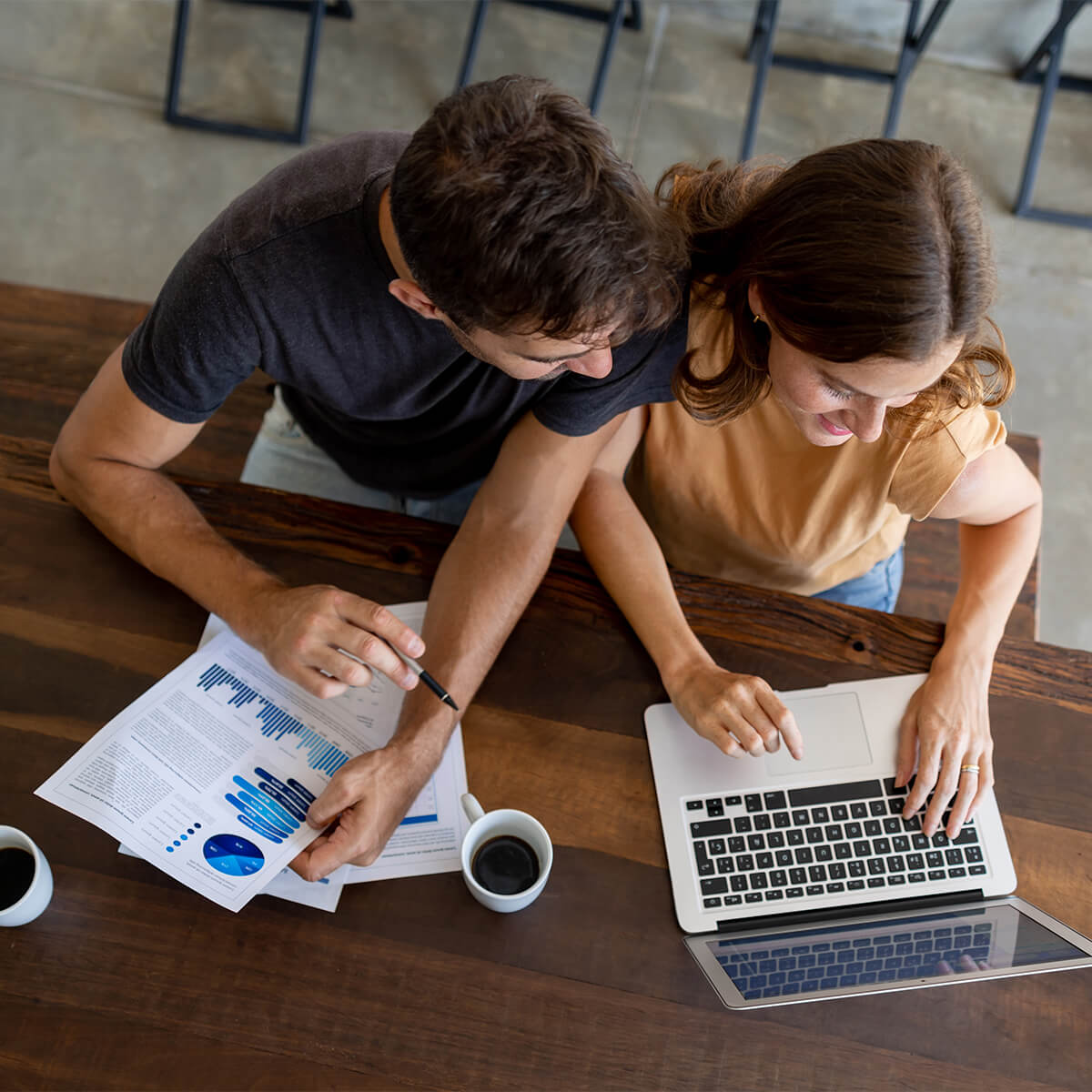 Happy couple paying bills online from home - stock photo