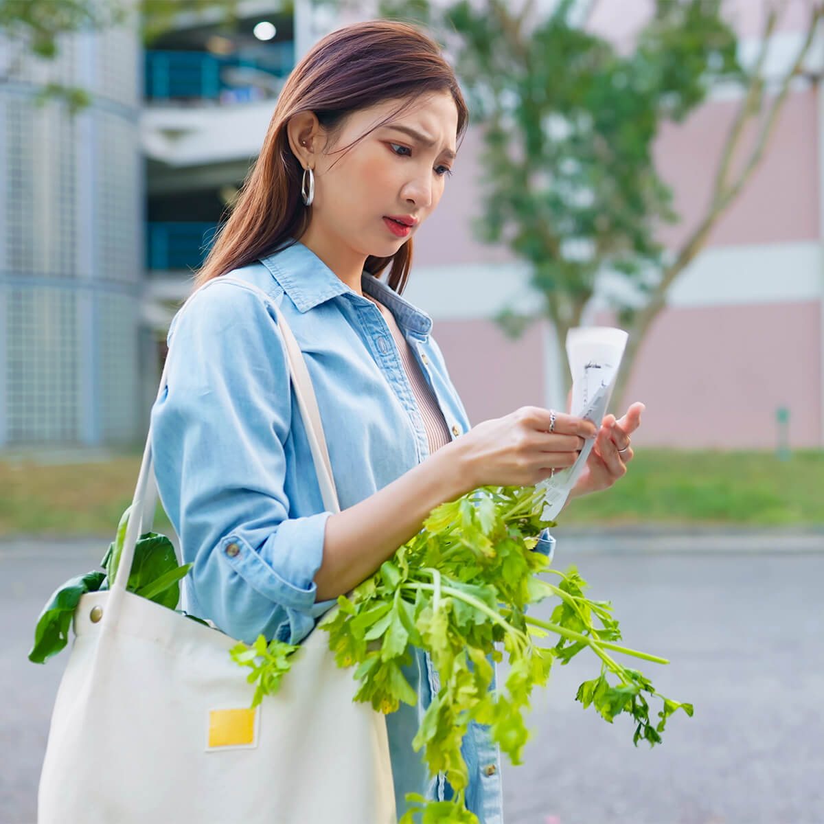 Woman looking at receipt after grocery shopping