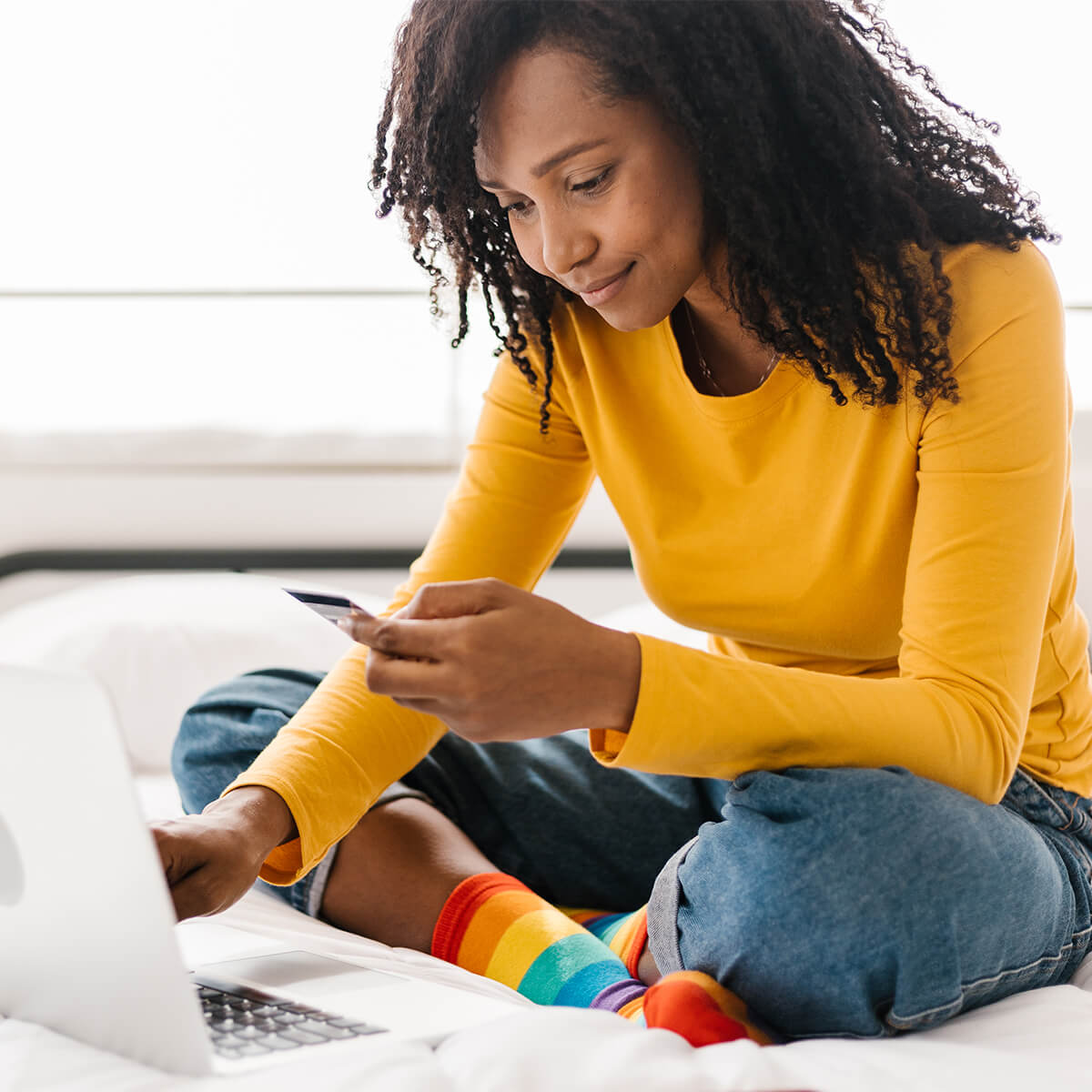 A newcomer to Canada looks at her credit card and laptop