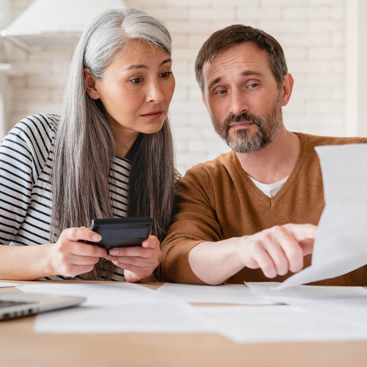 Mature middle-aged couple wife and husband family doing paperwork, paying bills, pension, financial documents operations transactions, divorce contract, bankruptcy, court case, health problems at home.