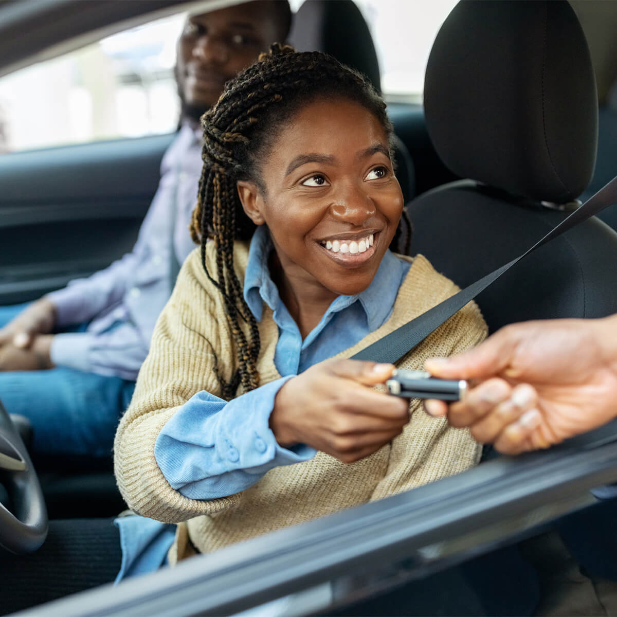Couple gets car keys for test drive at showroom