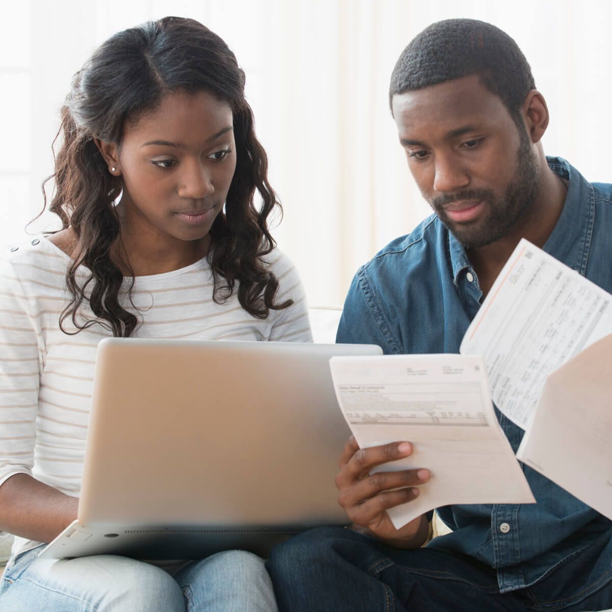 A couple looks at their bills and considers their debt options