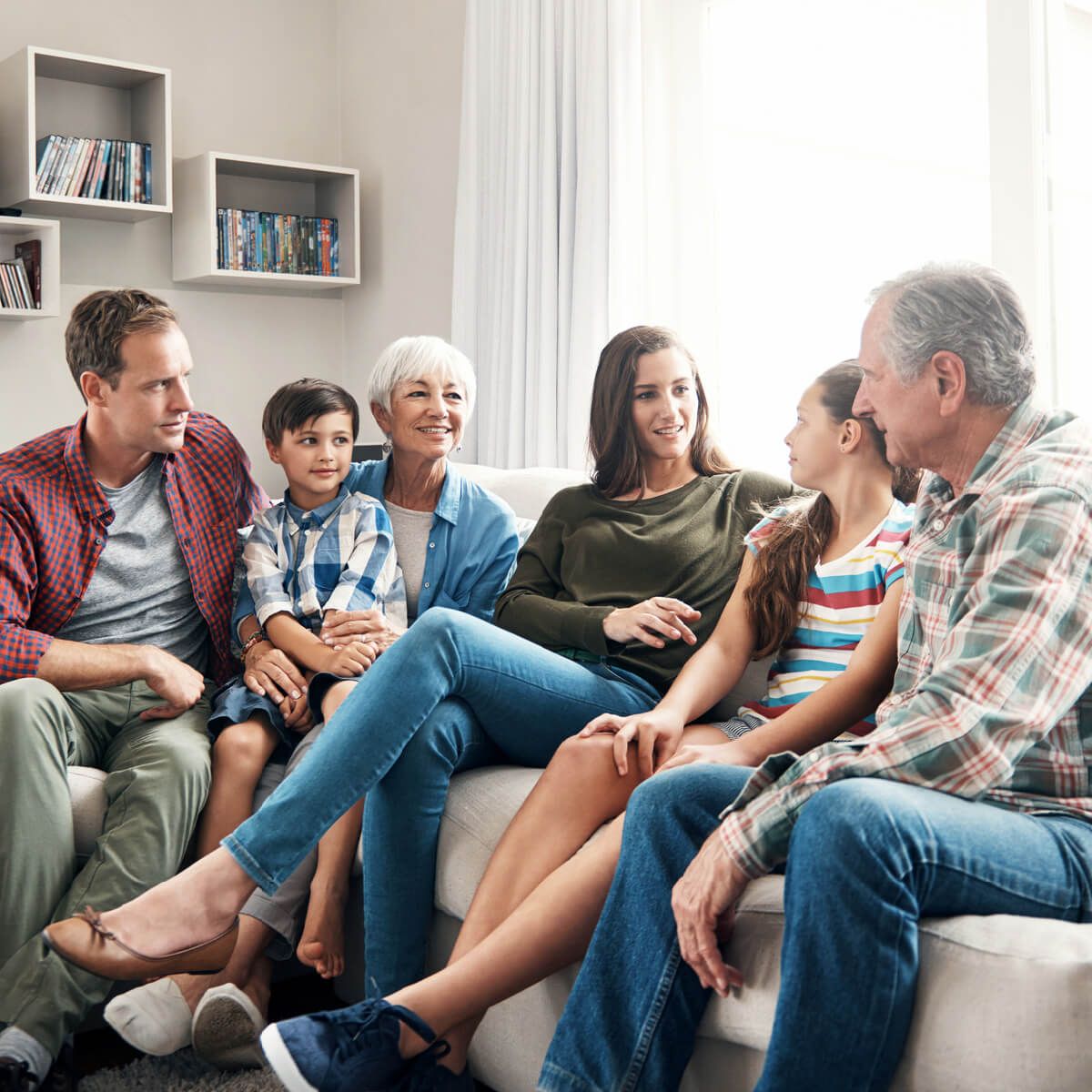 Big family sitting on sofa together